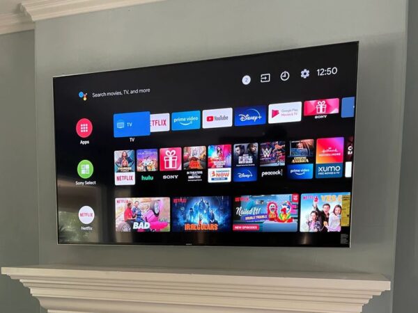 TV mounted above a white fireplace mantel